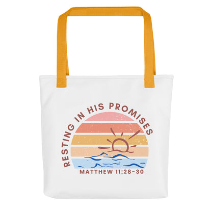 Front view of a white Christian tote bag with mustard yellow straps, featuring a retro sunset-and-waves graphic and the text “RESTING IN HIS PROMISES” with “MATTHEW 11:28–30” below.