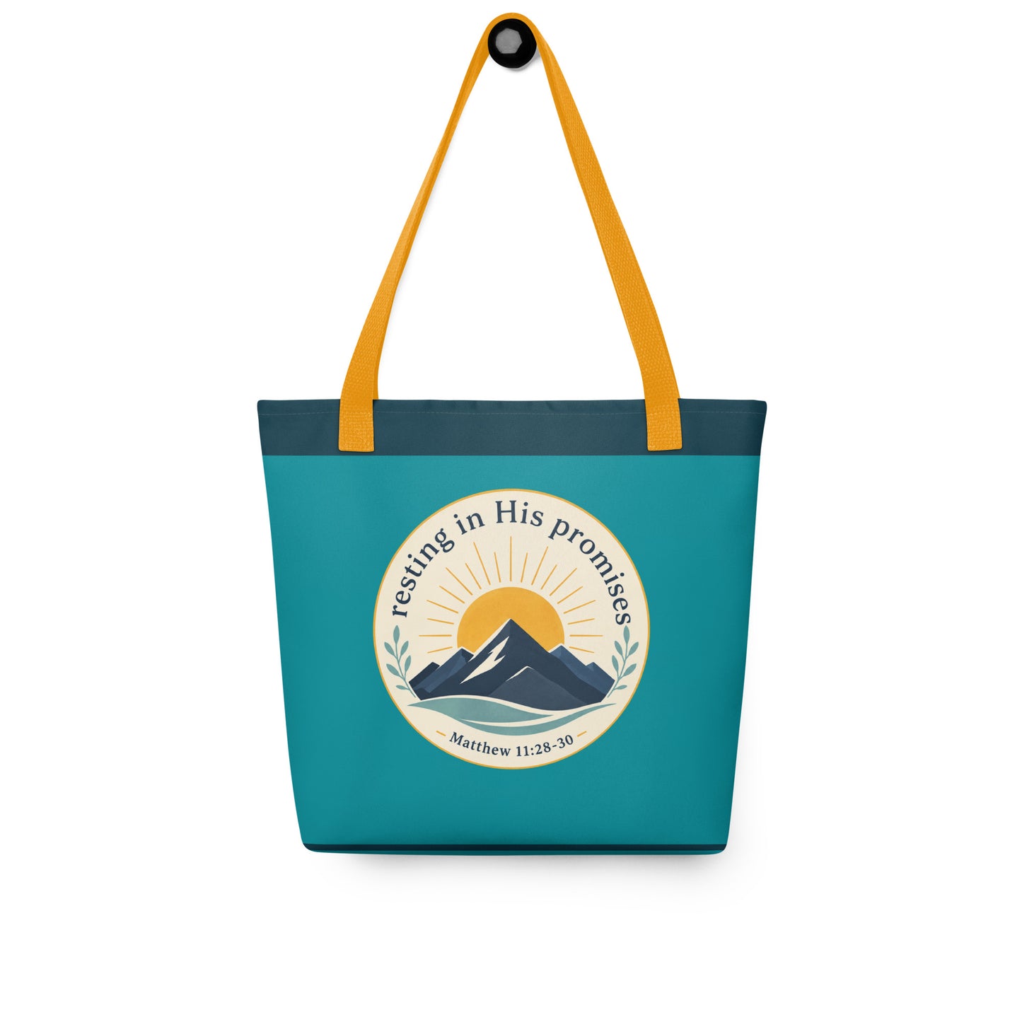 Christian tote bag hanging on a hook, featuring yellow straps, teal fabric, and a “Resting in His Promises” mountain and sunrise design.