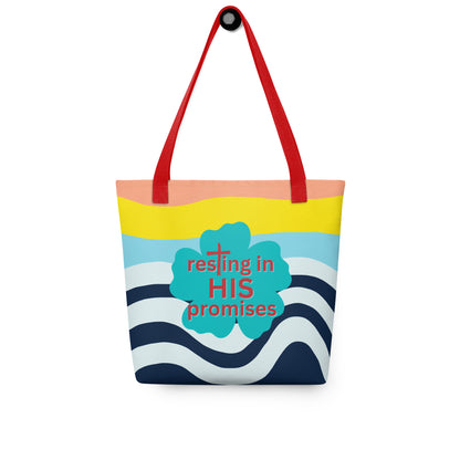 Tote bag hanging on a hook with red handles, wavy navy-and-white pattern, and teal “resting in HIS promises” clover graphic.