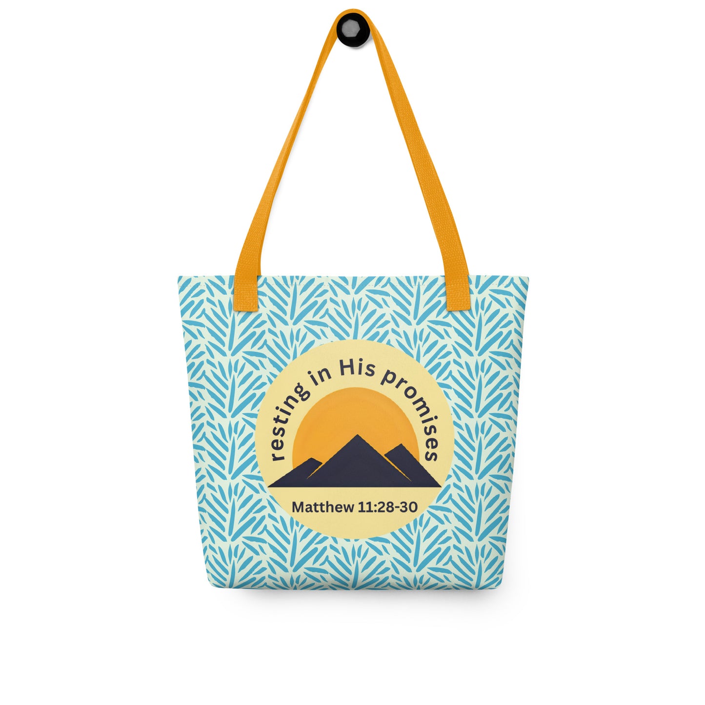 “Resting in His Promises” Christian tote bag hanging on a hook, featuring yellow handles, blue leaf pattern, and Matthew 11:28–30 emblem.