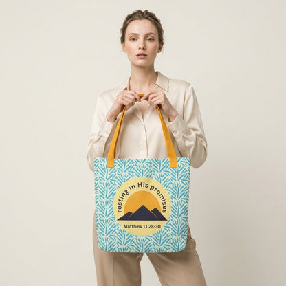 Lifestyle shot of a person carrying the “Resting in His Promises” Matthew 11:28–30 Christian tote with yellow handles and blue botanical pattern.