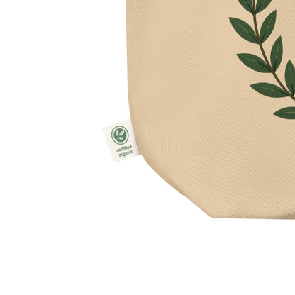 Close-up of the natural cotton tote fabric, showing the textured weave and a side “certified organic” tag detail.