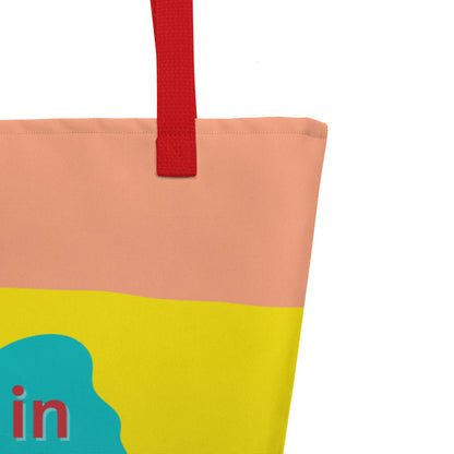 Close-up of the red woven handle, stitching along the top edge, and the peach/yellow/light color bands behind the teal flower graphic and red “resting in HIS promises” text.