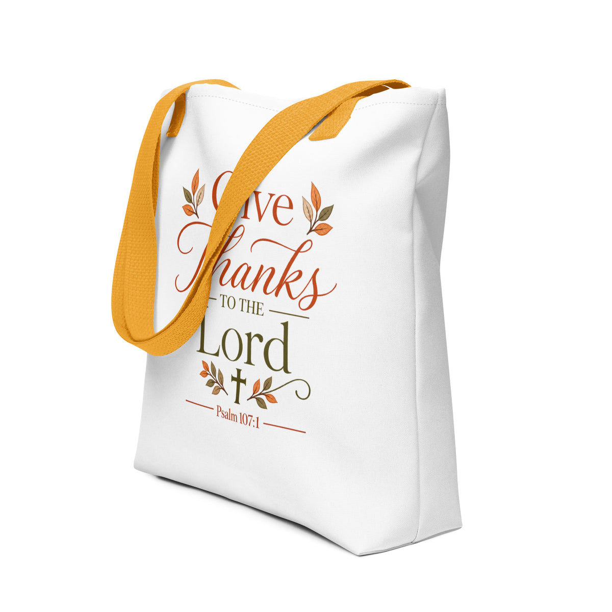 Angled view of a white Christian Thanksgiving tote bag with fall-inspired artwork, Psalm 107:1, and mustard yellow handles.