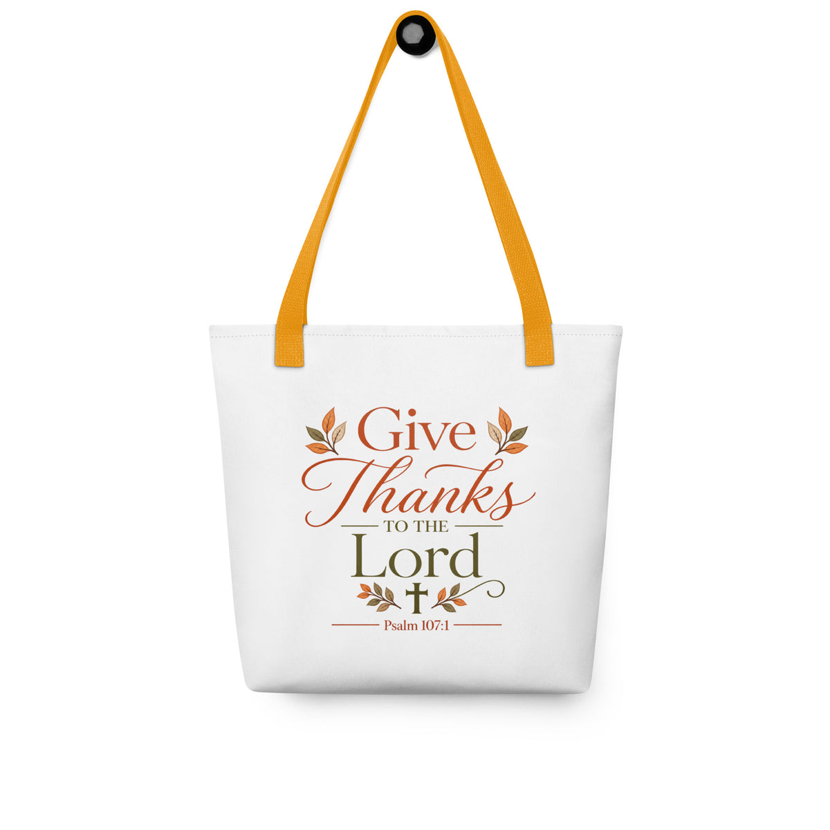 Christian fall tote bag hanging on a hook, featuring a “Give Thanks to the Lord” design with autumn leaves and a cross.