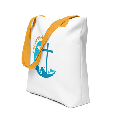 Angled view of a white tote with yellow straps showing “Psalm 93:4” above a blue wave design with a cross.